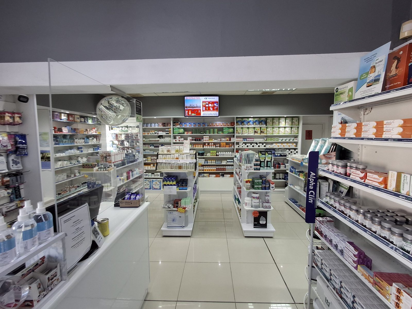 Inside Windermere Pharmacy: the shop floor with the dispensary and shelves of health products